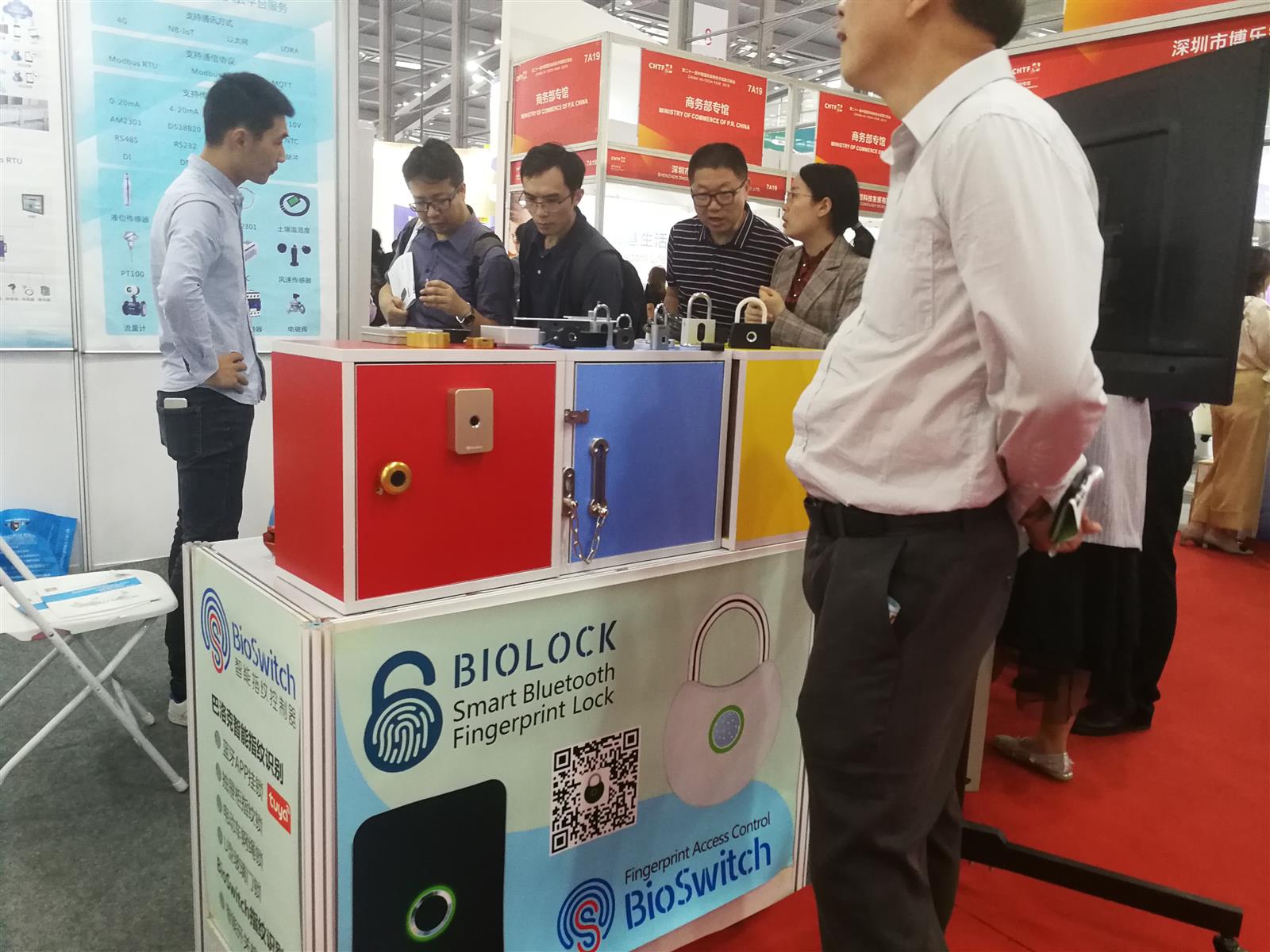 International visitors discussing BioLock smart fingerprint locks at a Shenzhen trade exhibition